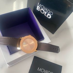 Rose gold face with brown band.